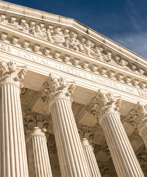 Front view of the United States Supreme Court building, showing its Corinthian columns and the engraving 